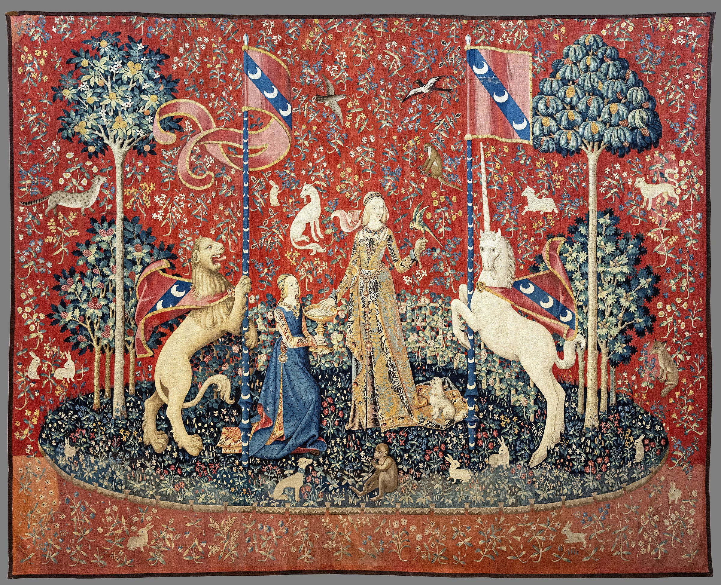 The Lady and the Unicorn tapestry for Taste, with the lady taking a sweet and a monkey eating nearby