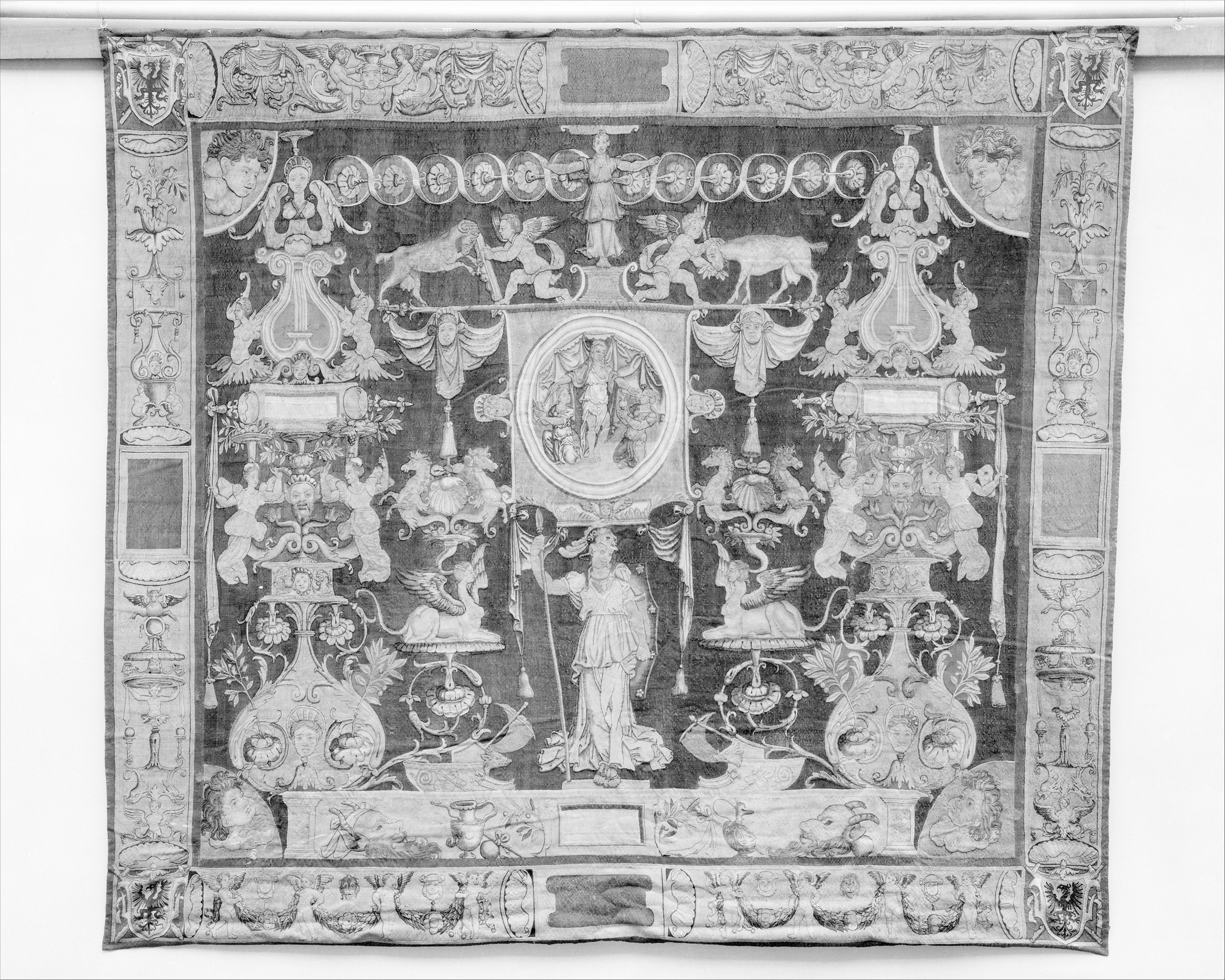 Minerva standing within an elaborate Renaissance tapestry of grotesques, medallions, masks, animals, and ornamental forms