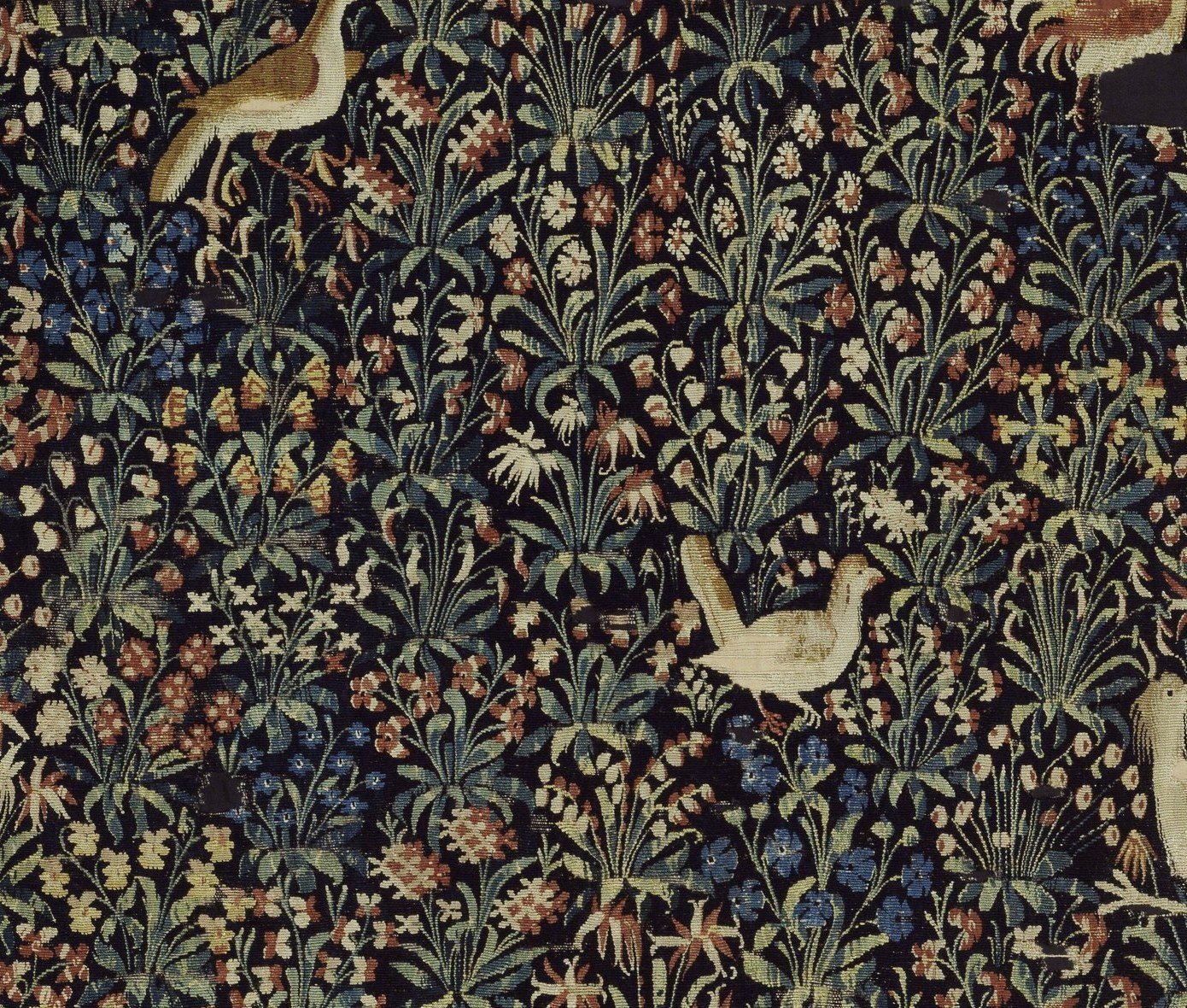 Editorial detail crop of small animals and flowering plants in a millefleurs tapestry